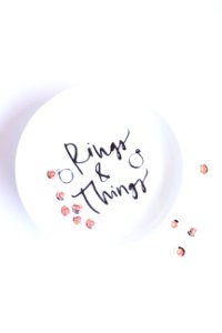 Silver-colored Rings On Round White Ceramic Plate