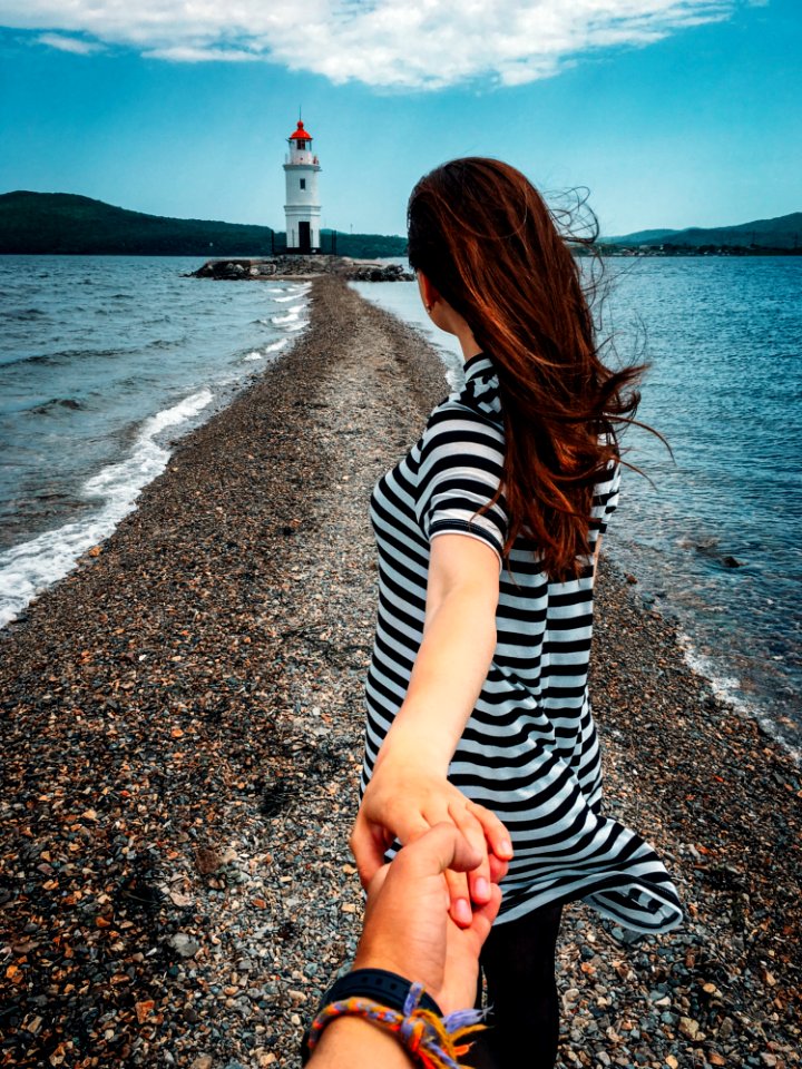 Woman In Stripes Holding Hands With Person Wearing Bracelets