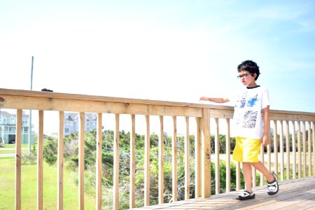 Boy Walking On Wooden Bridge photo