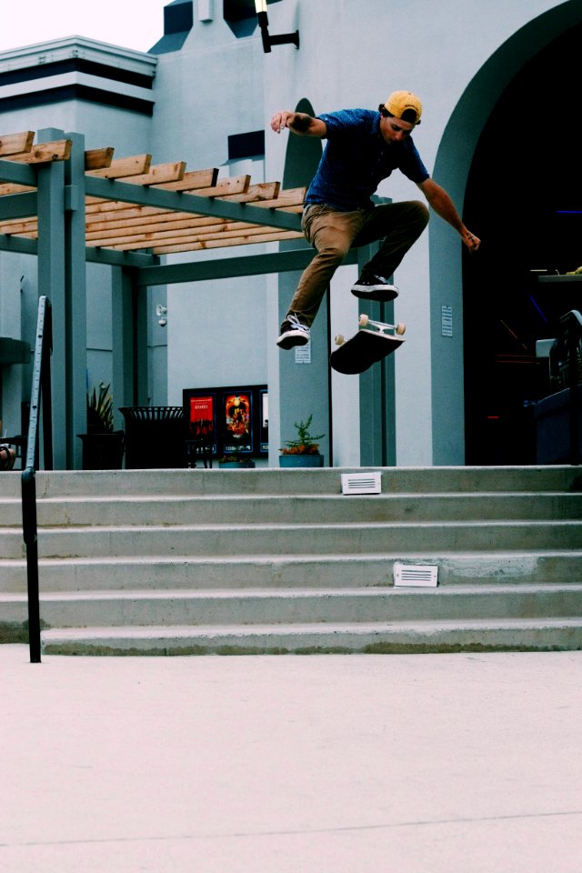 Man Jumping On Air Over Flipped Skateboard