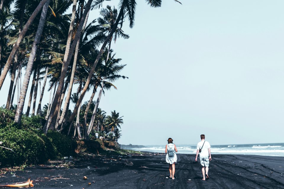Two People Walking By The Seashore