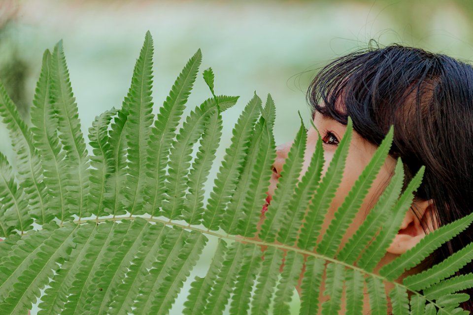 Green Leaf In Front Of Woman