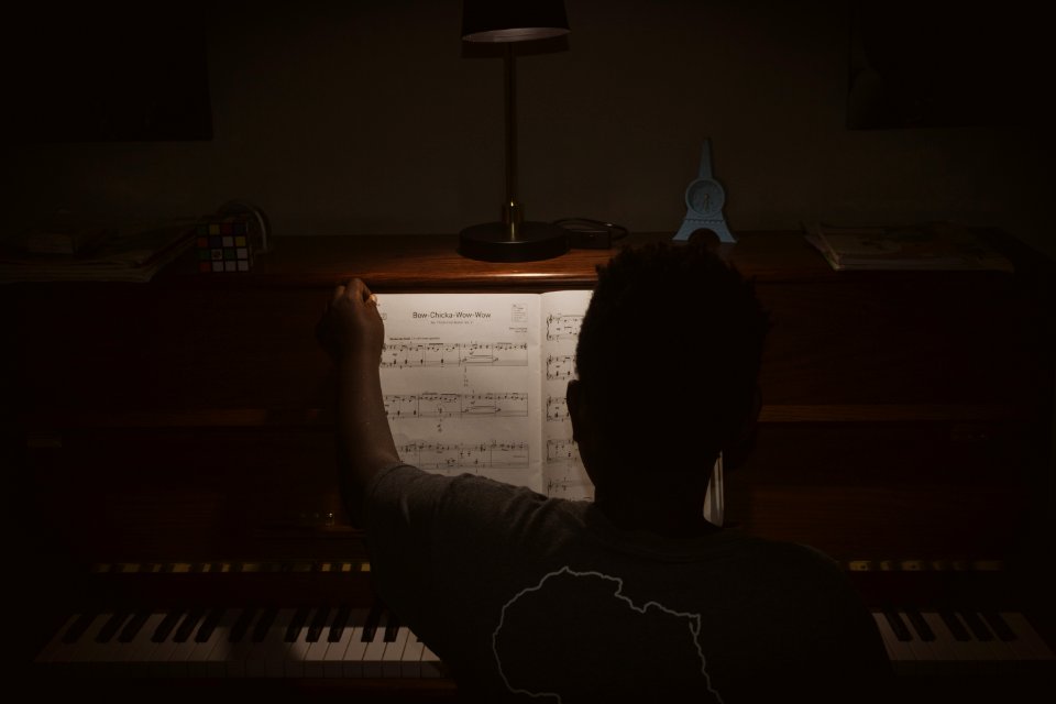 Photo Of Person Sitting In Front Of Piano