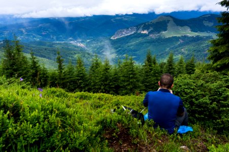 Man Wearing Blue Shirt Sitting On Green Grass