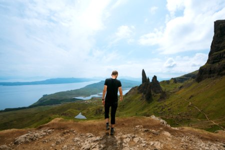 Man Wearing Black T-shirt Standing On Cliff photo