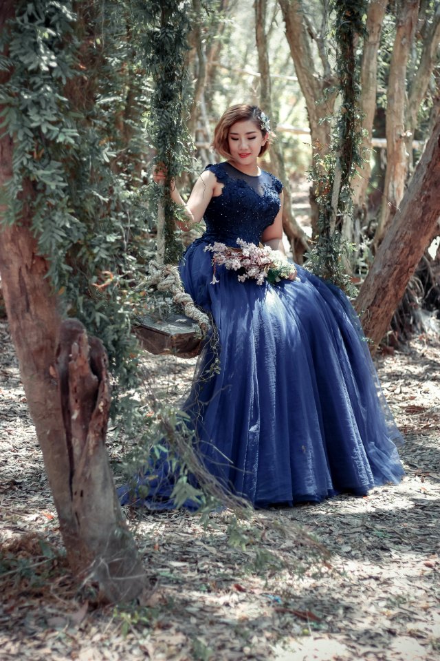 Woman In Black Floral Gown Sitting
