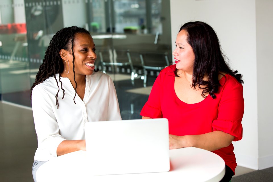 Woman In Red Shirt Beside Woman In White Shirt