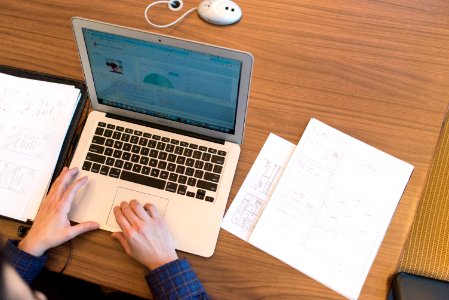 Persons Hands On Top Of Macbook Air