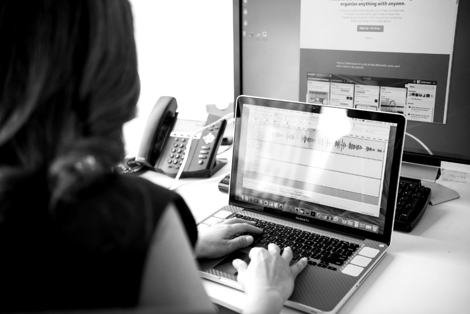 Grayscale Photo Of Woman Using Macbook Pro