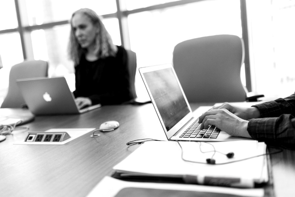Grayscale Photo Of Person Using Laptop Computer