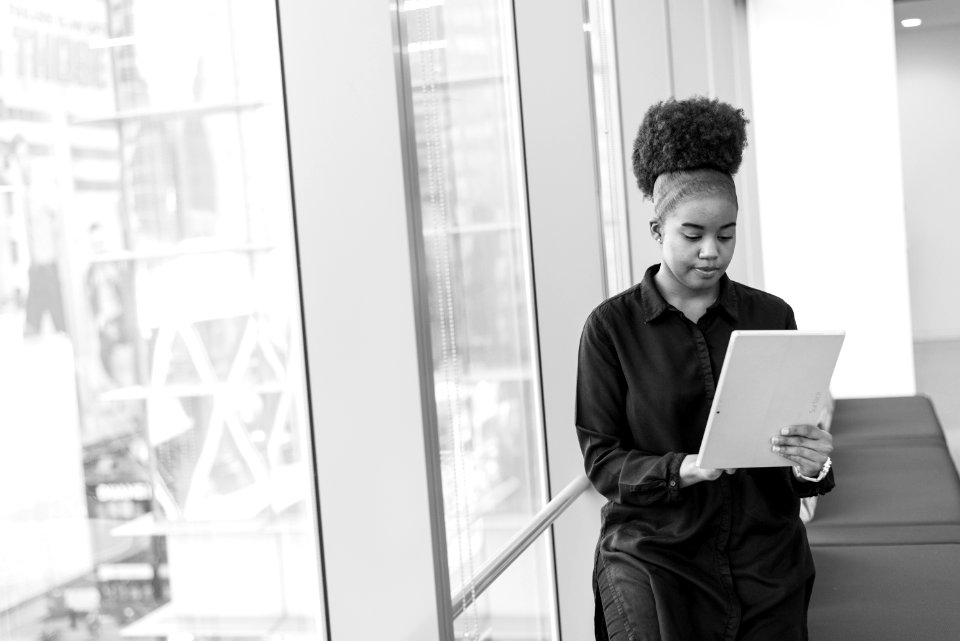 Grayscale Photo Of Woman Holding Tablet Computer
