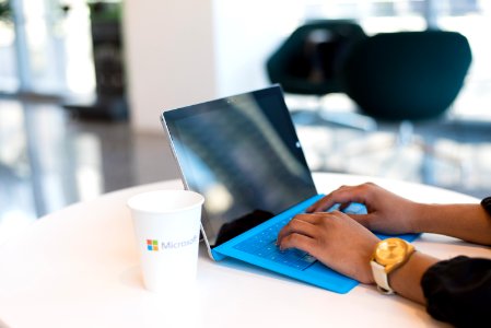 Person Browsing On Black And Blue Laptop Computer photo