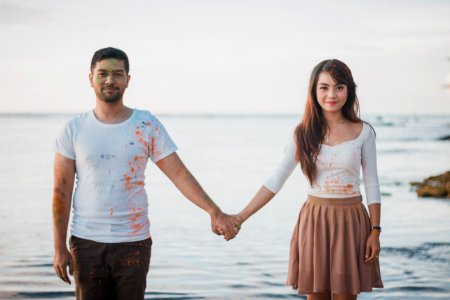 Man And Woman Standing Beside Body Of Water photo
