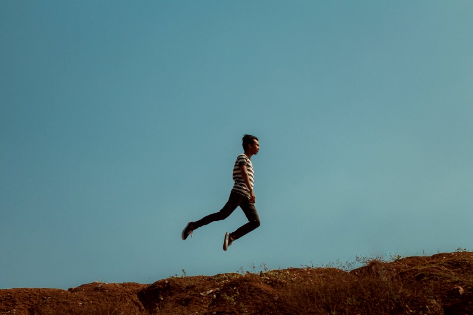 Man Jumping Near The Cliff