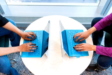 Two People Working On Laptops