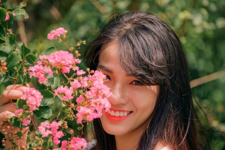 Photography Of Smiling Woman Near Flowers photo