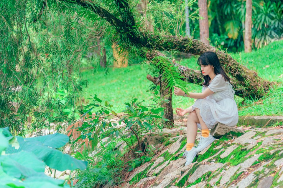 Photography Of Woman Sitting On Rock