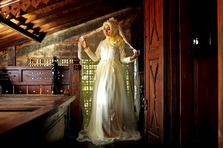 Women Wearing White Long-sleeved Dress Near Brown Wooden Door