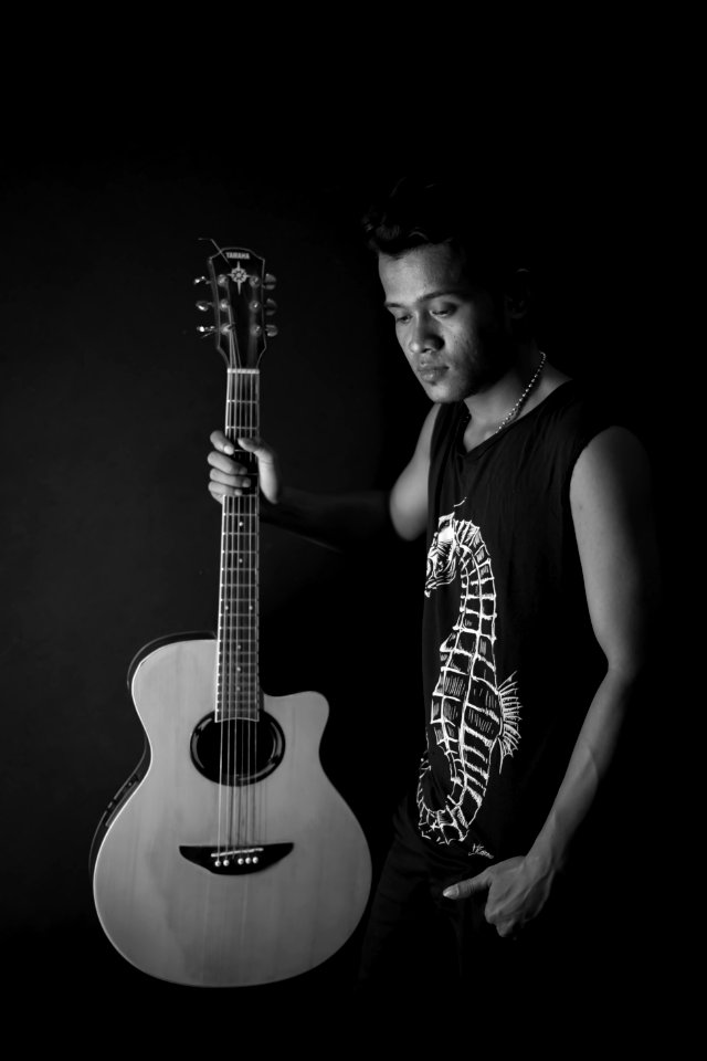 Man Holding Acoustic Guitar