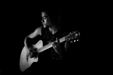 Monochrome Photography Of Man Playing Guitar photo