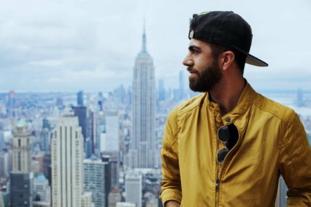 Portrait Photo Of Man In Yellow Zip-up Jacket Near Empire State Building photo