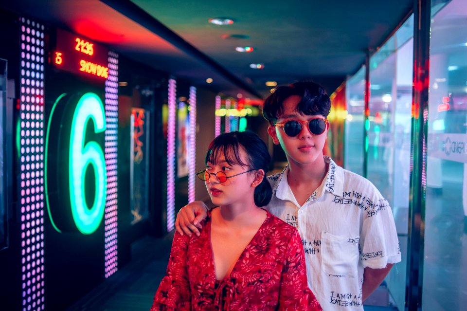Man And Woman Standing On Hallway Surrounded By Led Lights