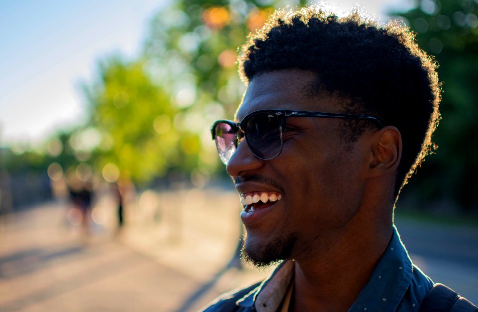 Man Wearing Blue Shirt Smiling Outside photo