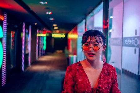 Woman Wearing Red Long-sleeved Top And Sunglasses On Hallway photo