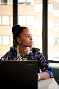 Woman Wearing Blue And Brown Floral Elbow-sleeved Dress Facing Black Lenovo Laptop Near Glass Window