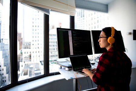 Woman Sitting While Operating Macbook Pro photo