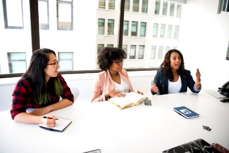 Three Women In Front Of Desk
