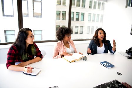 Three Women In Front Of Desk photo