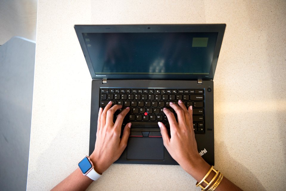 Human Hand On Black Lenovo Thinkpad