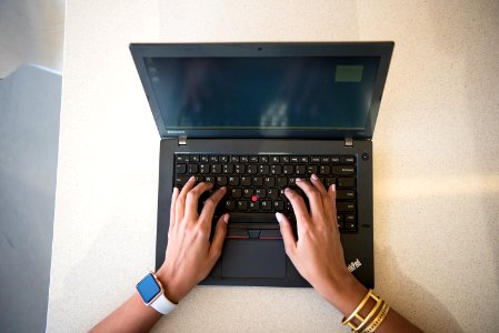 Human Hand On Black Lenovo Thinkpad