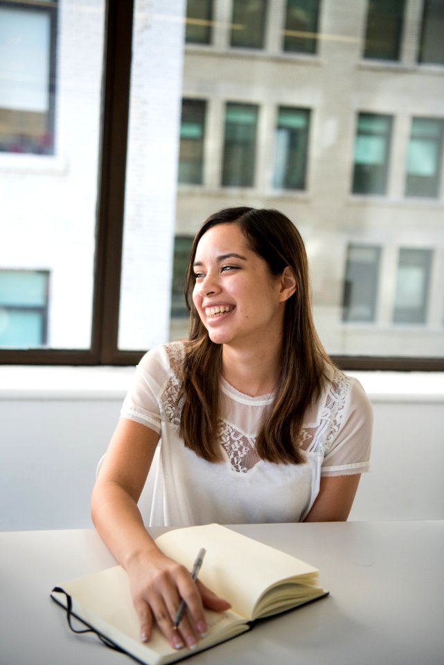 Woman Wearing White T-shirt Holding Notebook And Pen