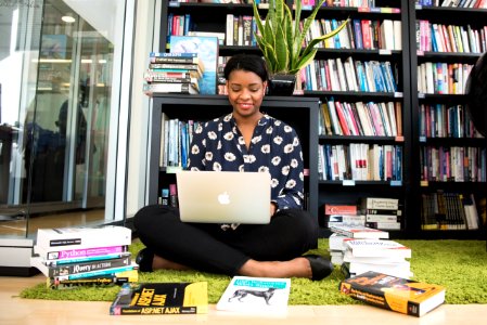 Woman In Black Shirt Using Macbook