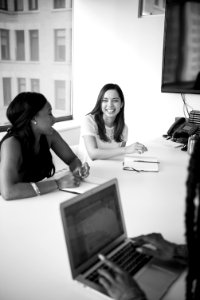 Two Women Behind Table photo