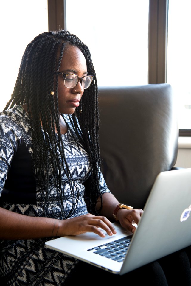 Woman Sitting Holding Silver Macbook