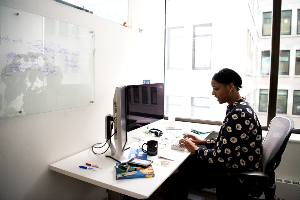 Woman Sitting In Front Of Computer Monitor