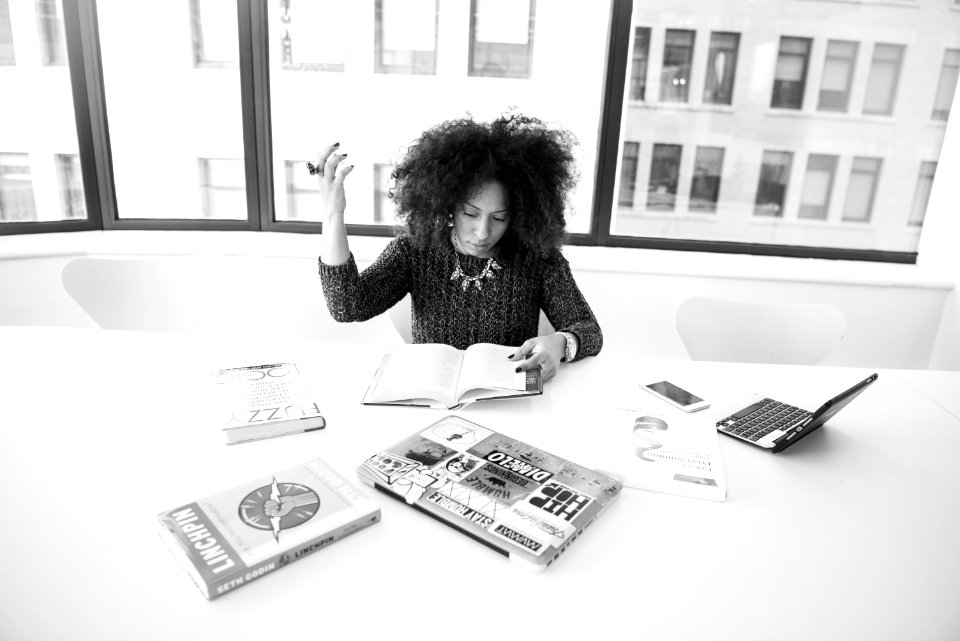 Woman Sitting While Reading Books Grayscale Photo photo