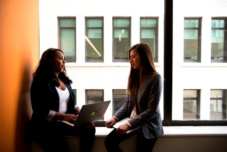 Woman Holding Laptop Computer Near Window photo