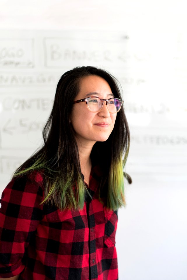 Shallow Focus Photography Of A Woman In Red And Black Checkered Dress Shirt