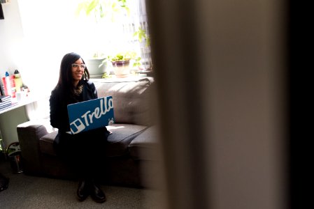Woman Using Blue And White Laptop Sitting On Sofa