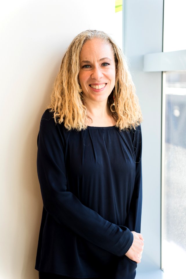 Woman Wearing Black Long-sleeved Shirt Leaning On Wall