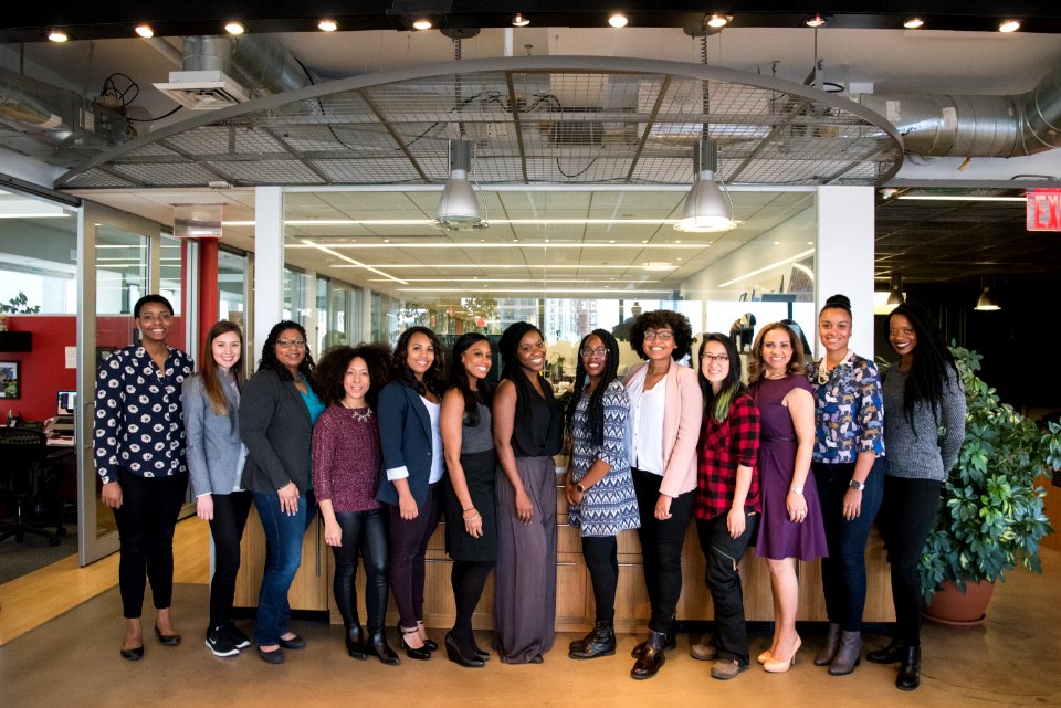 Group Of Women Standing Near Desk