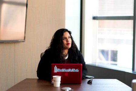 Woman Wearing Black Long-sleeved Shirt Using Red Macbook photo