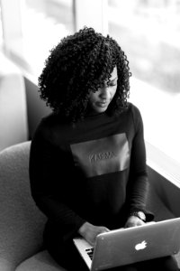 Monochrome Photography Of Woman Using Laptop
