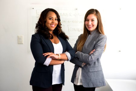 Two Smiling Women In Gray And Black Coat photo