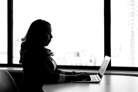 Grayscale Photography Of Woman Using Laptop photo