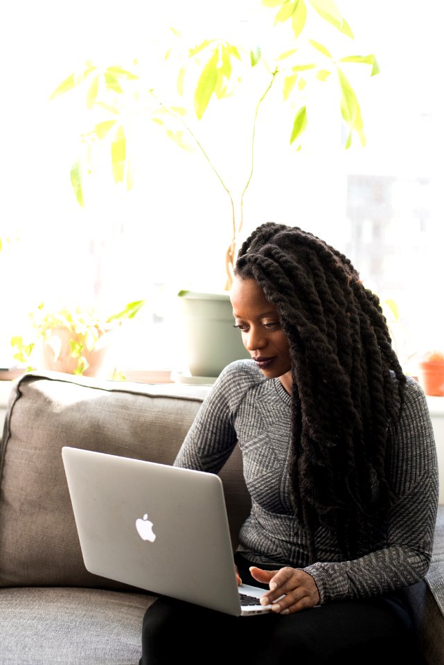 Woman In Gray Sweater Using Macbook Pro